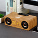 Wooden clock radio with digital display on a desk
