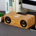 Wooden clock radio with digital display on a desk
