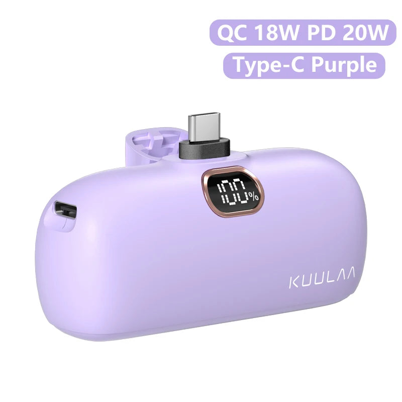 Purple power bank with digital display and charging ports on a white background