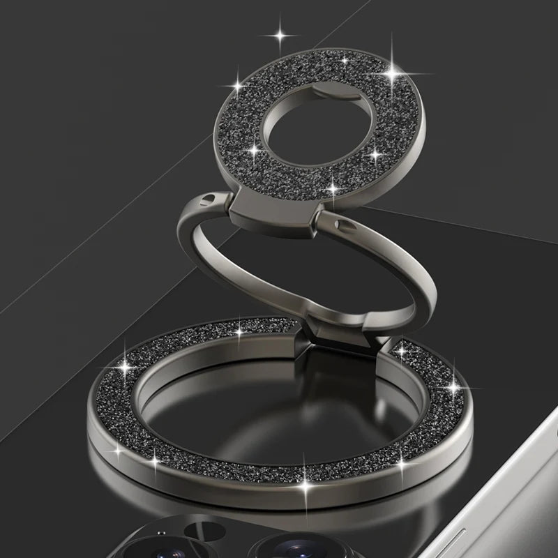 Silver ring holder with gemstone accents on a reflective surface