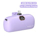 Purple power bank with digital display and charging ports on a white background