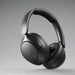 Over-ear wireless headphones in black color with a noise-cancellation feature, shown with a detachable cable and a 3.5 mm jack.