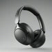Over-ear wireless headphones in black color with a noise-cancellation feature, shown with a detachable cable and a 3.5 mm jack.