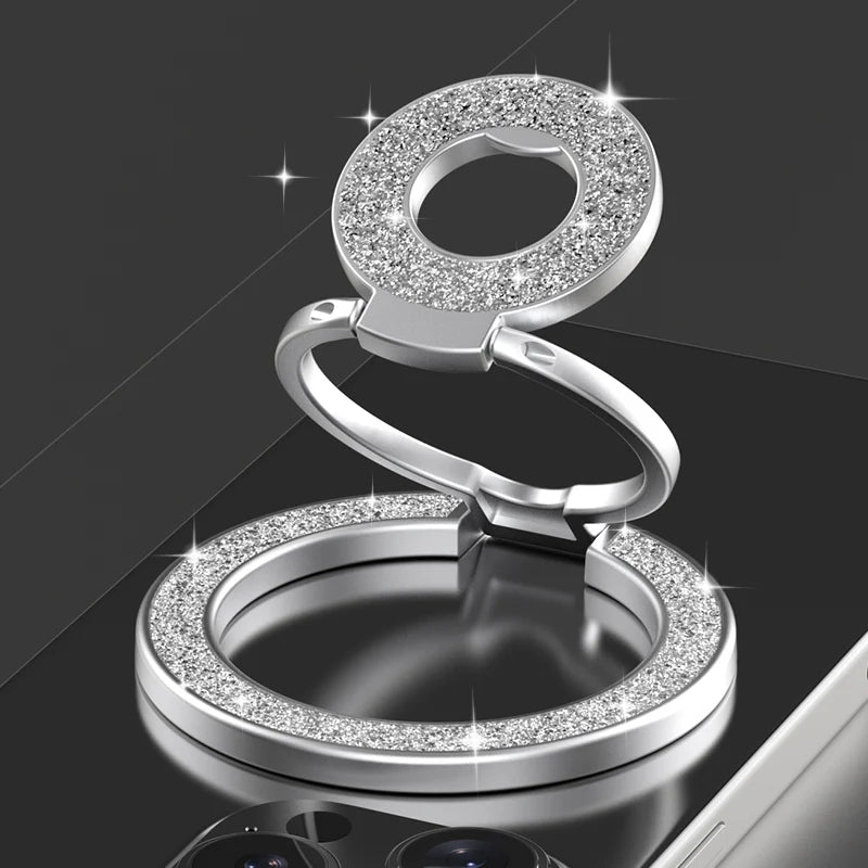 Silver ring holder with gemstone accents on a black background