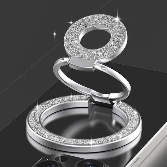 Silver ring holder with gemstone accents on a black background