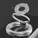 Silver ring holder with gemstone accents on a black background