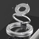 Silver ring holder with gemstone accents on a black background